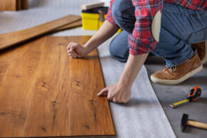 a flooring fitter laying engineered wood flooring
