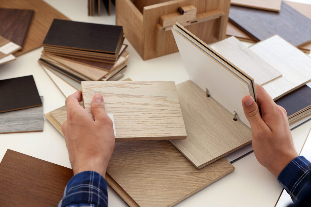 a man getting bathroom flooring ideas by looking through samples
