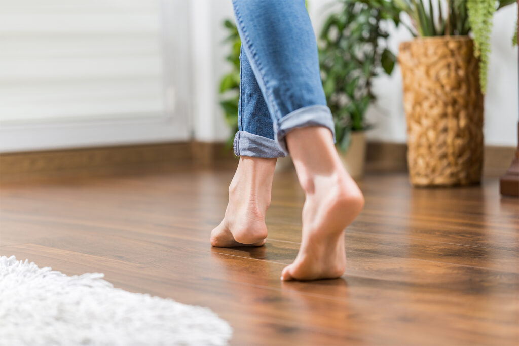 a homeowner walking on engineered wood flooring barefoot