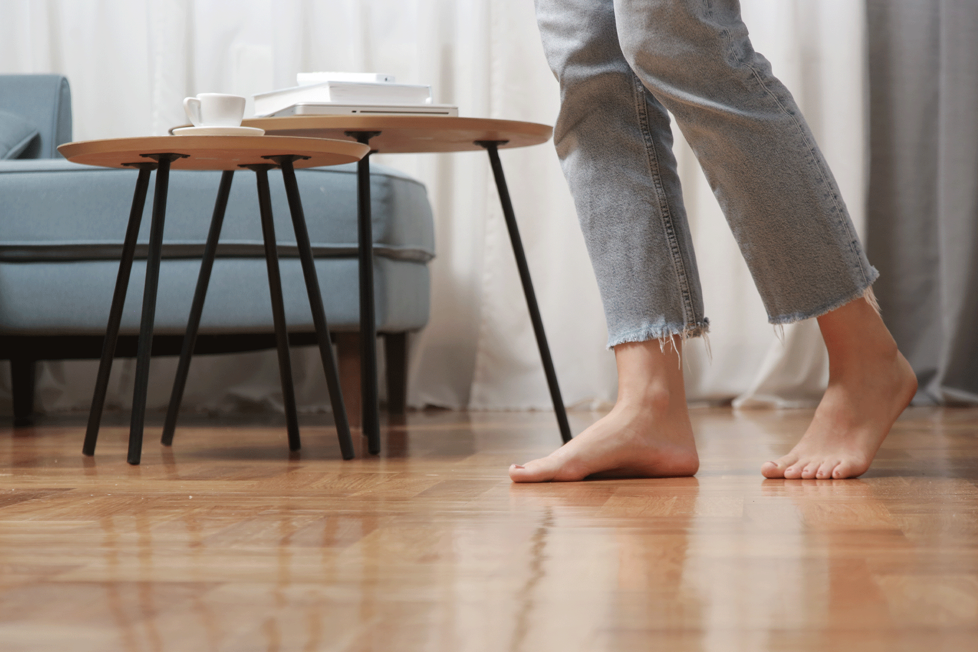 Closeup of a woman walking barefoot on floor with underfloor heating.