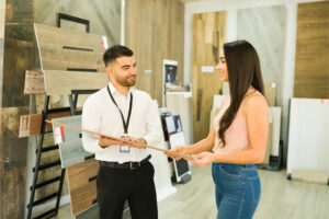a homeowner looking at different kinds of flooring in a flooring shop